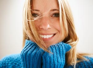 Smiling girl in blue sweater